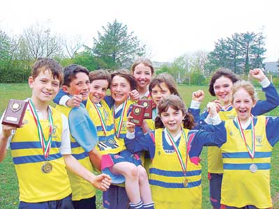 The school’s cross-country team (pictured in yellow vests) have also won medals.