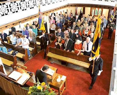 Rev. Chris Rees receiving the standards in to Bethesda Chapel during Narberth’s civic service. Pic. Malcolm Richards Photography