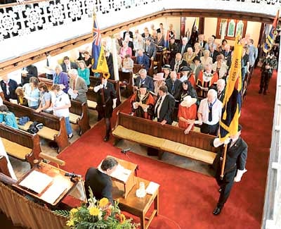 Rev. Chris Rees receiving the standards in to Bethesda Chapel during Narberth’s civic service. Pic. Malcolm Richards Photography
