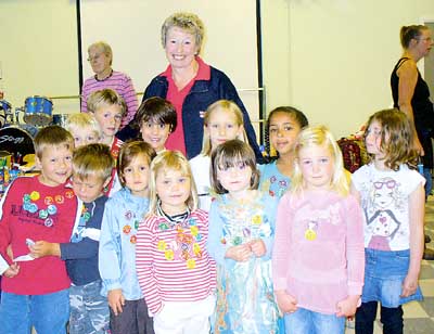 Children from the infants section of Tavernspite School are pictured with RNLI volunteer Jennie McIntosh after completing laps of the school playing field.