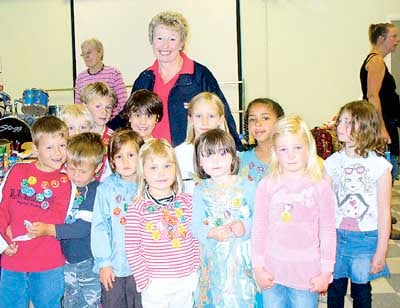 Children from the infants section of Tavernspite School are pictured with RNLI volunteer Jennie McIntosh after completing laps of the school playing field.