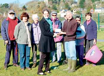 David Anderson, of the the Begelly and Kilgetty Community Association, receives a cheque from head of HR at Folly Farm, Kate Beynon.