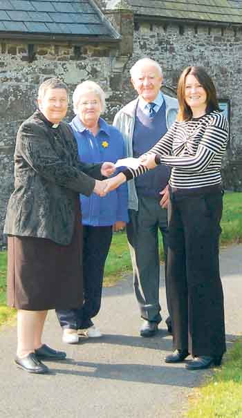 Rev. Sarah Geach and the church wardens from St. Mary’s receive their donation from Zoë Wright, Folly Farm’s head of marketing.
