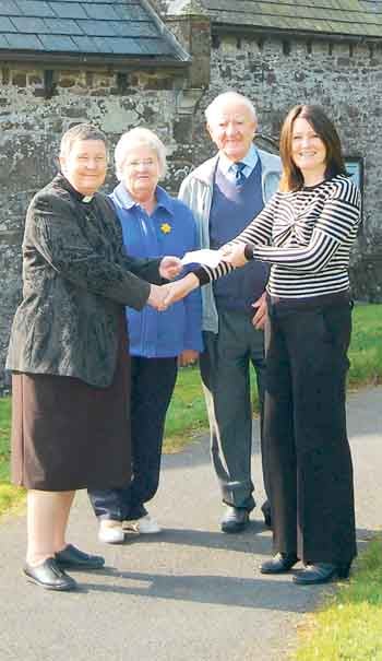 Rev. Sarah Geach and the church wardens from St. Mary’s receive their donation from Zoë Wright, Folly Farm’s head of marketing.