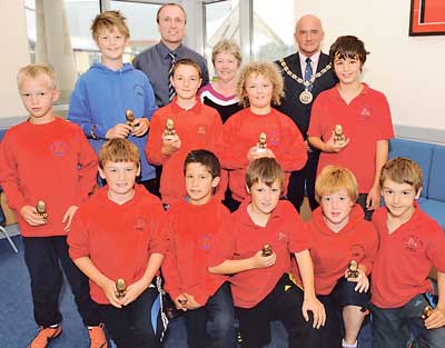 Clr. Peter Morgan who made the presentations to the Narberth CP School Urdd Rugby team. Mr. Paul Harries and head Mrs. Edna Davies with the team, Jordan, Kaleb, Talfan, Lewys, Harri, Bruce, Cai, Rhys and Tomas. The finals were played at Neath, where the team achieved a third place.
