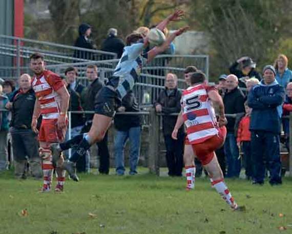 A Newcastle Emlyn kick charged down by a high-flying Narberth player.