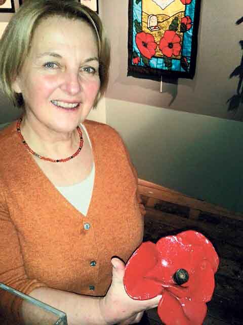 Museum curator Pauline Griffiths with the Tower poppy on display.