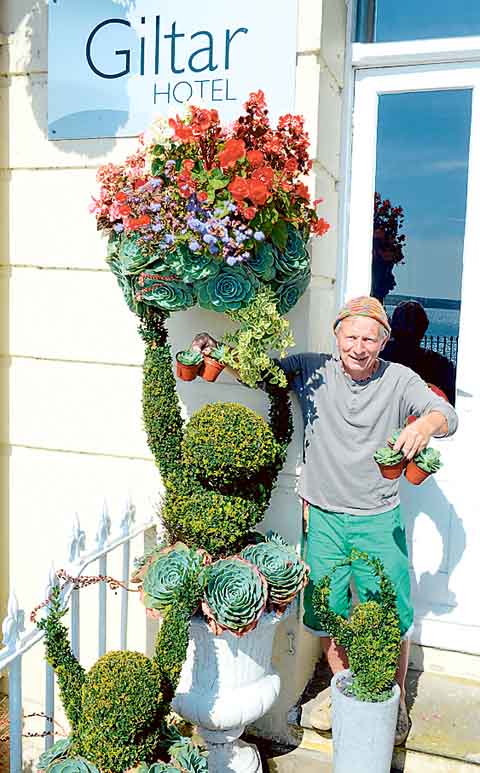 Simon, the Giltar Hotel’s gardener, celebrates the Wales in Bloom victory.