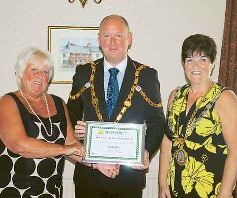 Deputy Mayor of Usk, Dave Harding, presents Mayor of Tenby and Tenby in Bloom chairman, Clr. Mrs. Sue Lane, and Clr. Mrs. Tish Rossiter with the second place silver gilt award.