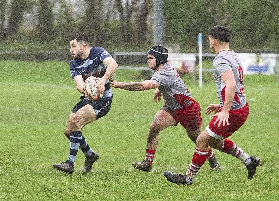 Lewys Gibby passing out to an Otter whilst being hounded by Trenanos back row back row. Pic Elwyn Davies