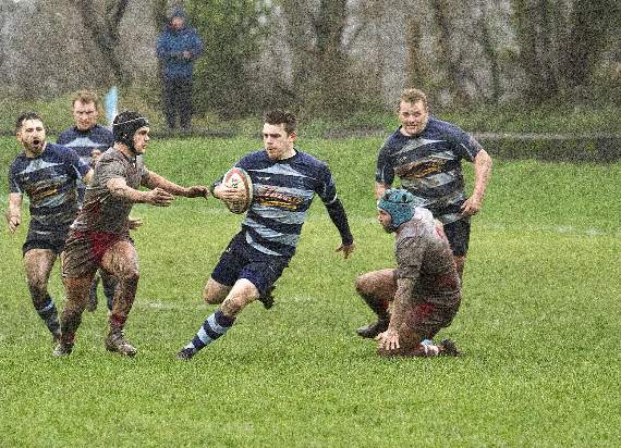Dafydd Pritchard breaking through a gap evading Trebanos back row forwards. Pic Elwyn Davies