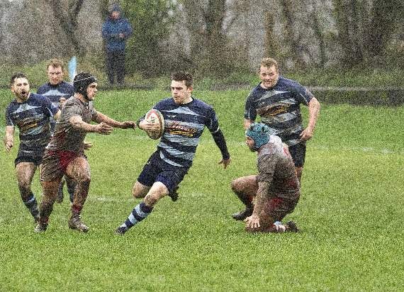 Dafydd Pritchard breaking through a gap evading Trebanos back row forwards. Pic Elwyn Davies