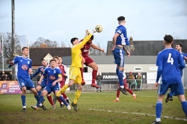 The Sheerwater goalkeeper clears a Farnham Town corner. Photo by Farnham Town Football Club