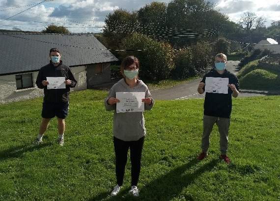 Tom Clarkson, Jenny Washbourne, and Jamie Jenkins receiving their certificates.