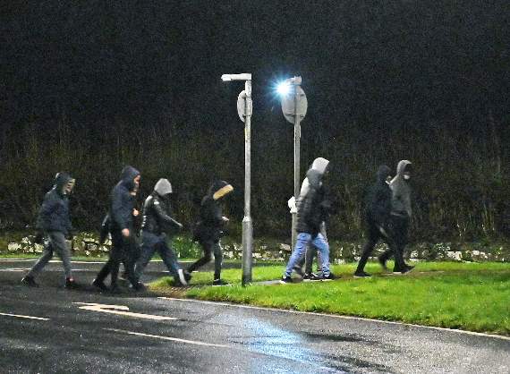 Some of the asylum seekers seen heading back to Penally after staging a protest march on Wednesday night into Tenby (Pic. Gareth Davies Photography)