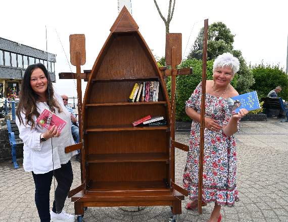Rhianydd Foster and Nina Thomas with the nautical themed bookcase (Pic. Gareth Davies Photography)