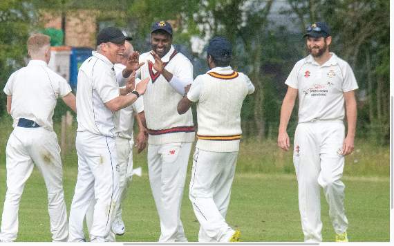 Balasingham Sivathas is congratulated after taking a catch.