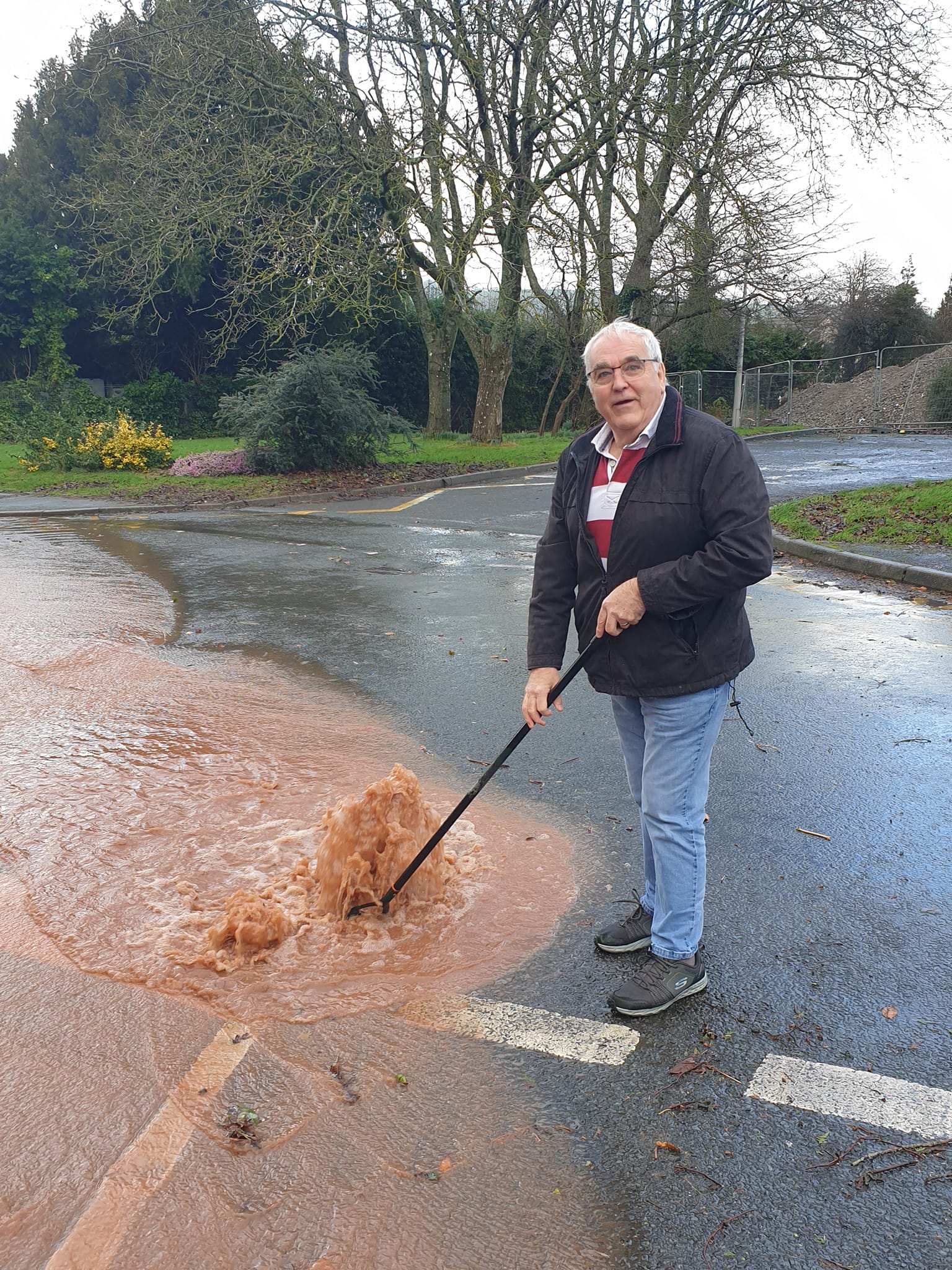 Tony Skyrme BEM takes direct action to release a blocked drain in Talgarth