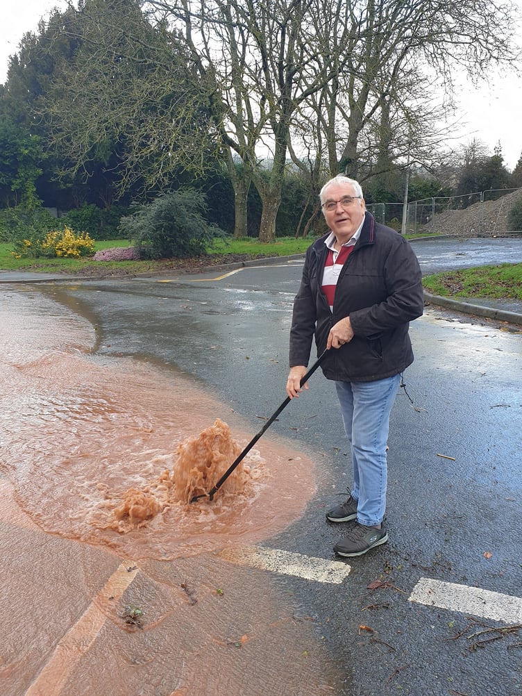 Tony Skyrme BEM takes direct action to release a blocked drain in Talgarth