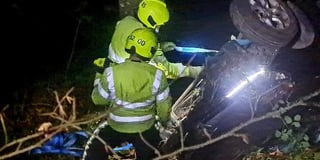Men escape with cuts and bruises after car plunges 30 feet down embankment