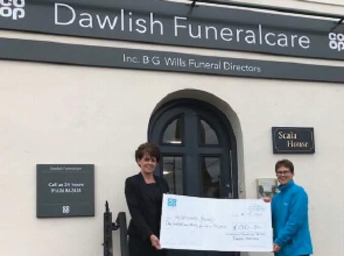 Jennifer Lightfoot, of Rowcroft Hospice, receives a ‘big cheque’ from Ceri Lee, funeral arranger.