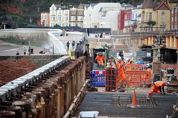 The Orange army hard at work near Dawlish station. Picture by Steve Pope.