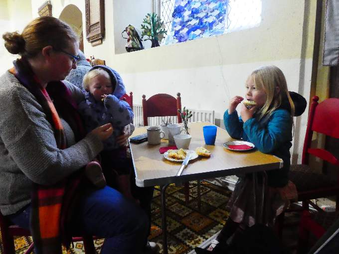 A young family enjoying the refreshments at the Cheriton Fitzpaine Church coffee morning.