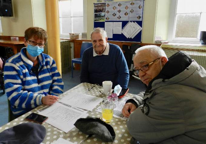 Caroline ( a helper), Graham and Chilton enjoying a cuppa and a quiz. NP 040222 05