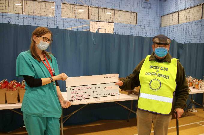 Dr Jo Harris, left, presenting a cheque for £1,200 to the Rotary Club of Crediton Boniface. AQ 4946