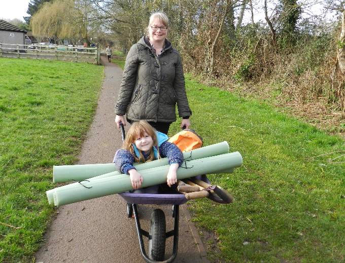 A fun way for Elisa Reece and Mae Lin Gillam (4) to arrive for the planting at Lords Meadow. NP 230222 01