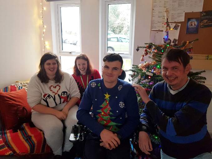 Feeling festive. Able (second right) and some friends in his new apartment