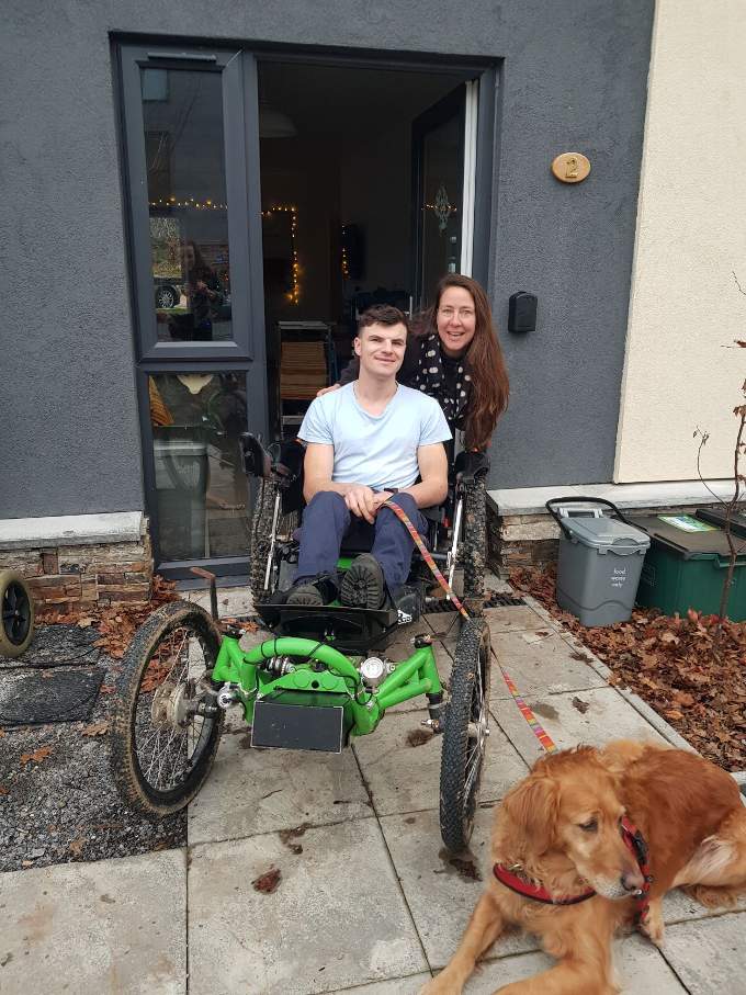 Getting mobile. Able on his Boma all-terrain wheelchair with support worker Cassie and family dog Merry.