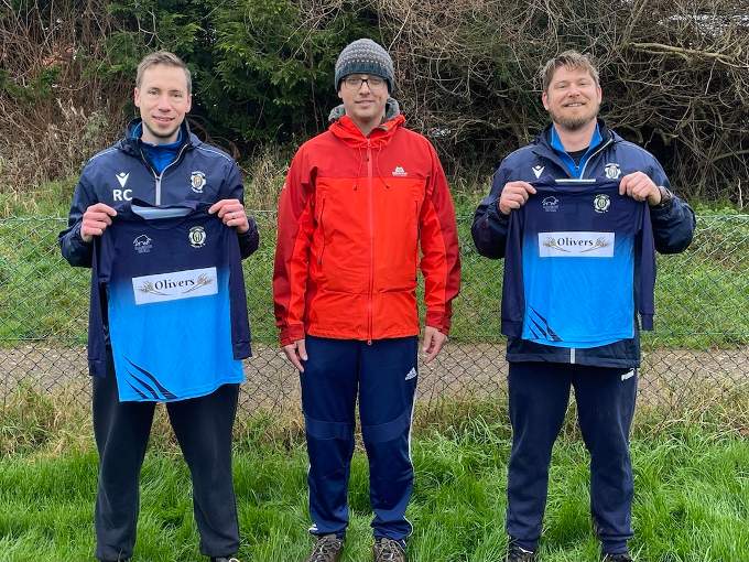 Rob Cereda, Crediton Youth U8 Coach, left, with James Cavender from Oliver’s Bakery, centre, and right, Tom Whedal, Crediton Youth U8’s Coach with two of the new shirts.