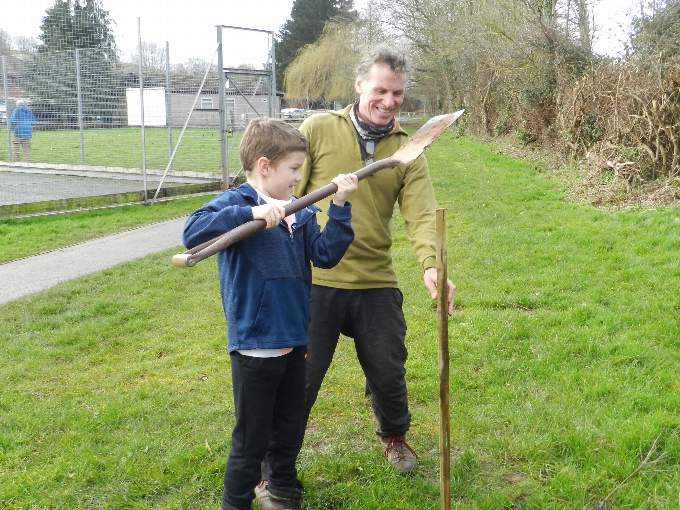 Alf (7) and Andrew planting a tree.