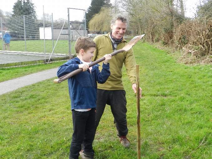 Alf (7) and Andrew planting a tree.
