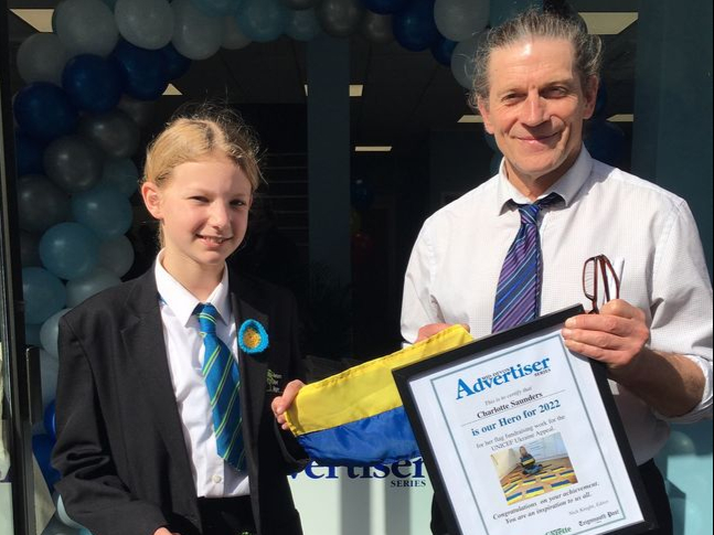 Flag fundraiser Charlotte Saunders receives a certificate from Mid-Devon Advertiser editor Nick Knight at the opening of the paper's new offices in Newton Abbot