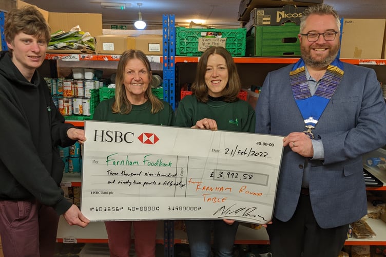 Farnham Round Table’s Mark Potter and Andrew Patience present the cheque to Farnham Foodbank’s Harriet Lanyon and Mel Cracknell