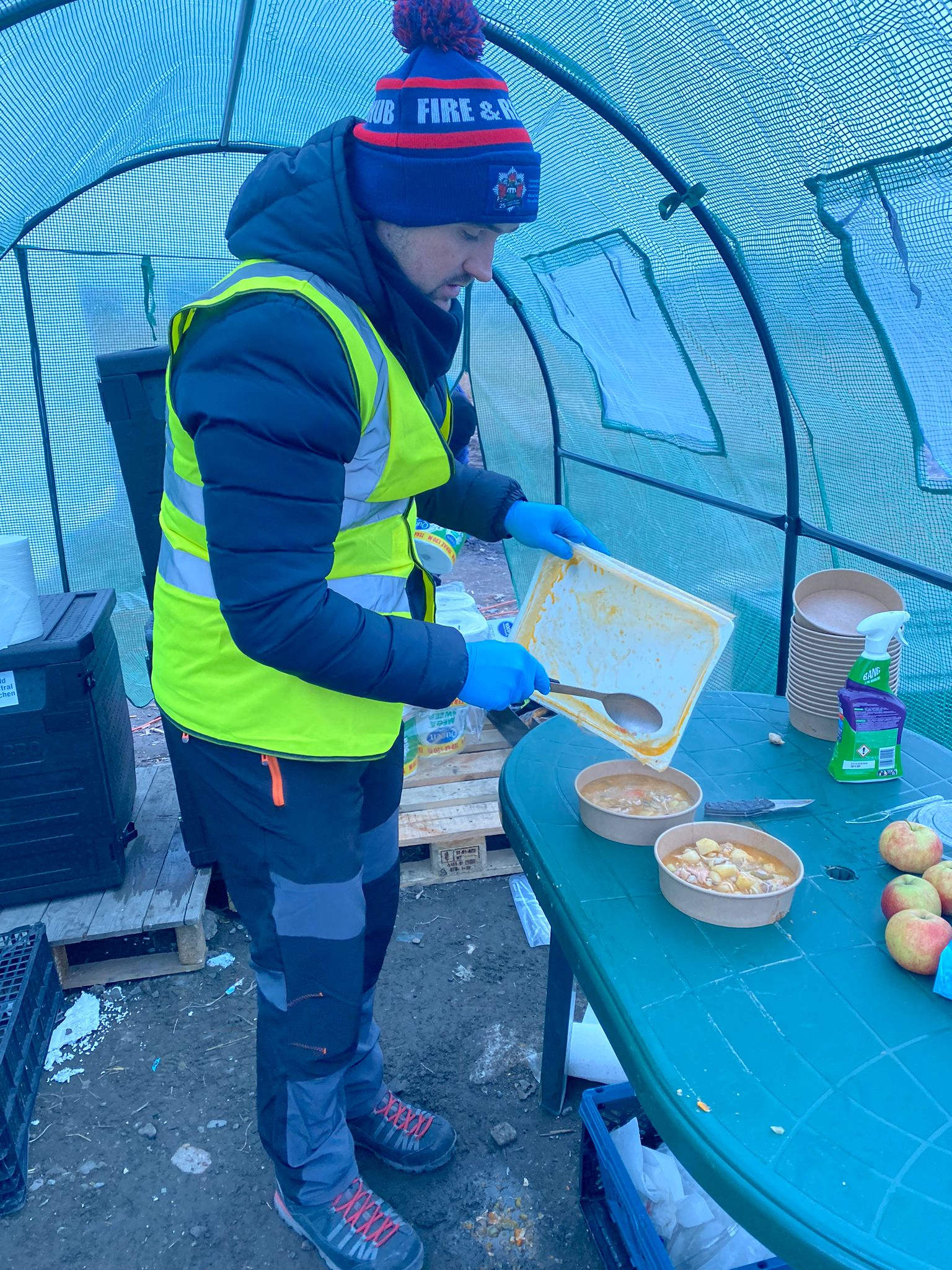 Nathan serving hot food for refugees