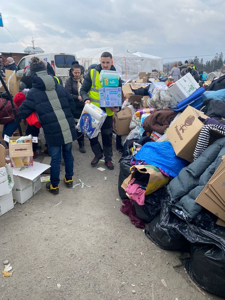 Sorting through donated supplies, including nappies, for refugees