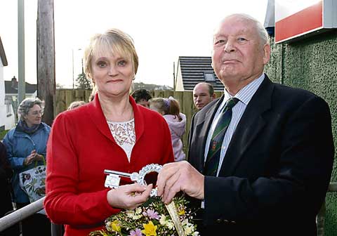 KEY TO THE FUTURE:  Handing over the ceremonial key to Jeanette Hendrie at the official opening of the Kabin Shop at St Giles-on-the-Heath is Ken Carroll.
