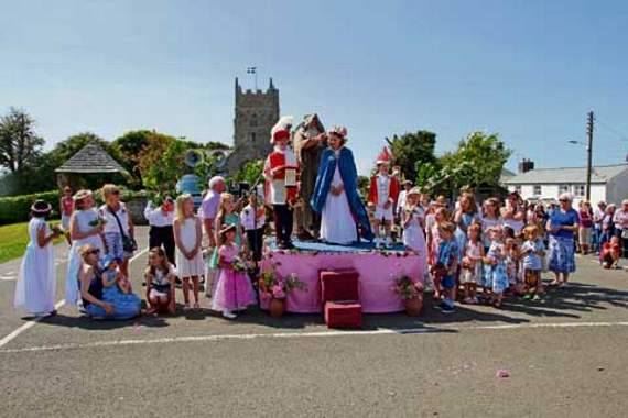 Old Father Time is pictured crowning this year’s Revel Queen Eleanor Bunting in front of a large crowd at the annual Marhamchurch Revel held on Monday, August 17. Picture: Paul Hamlyn