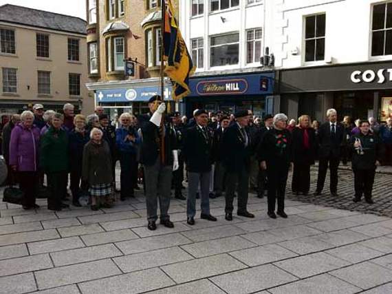 Launceston Royal British Legion members observed a two-minute silence at 11am in the town square on Armistice Day, November 11. Town crier Rob Tremain led the short service with Ann Brown from Launceston Town Band sounding the Last Post. The Legion Exhortation was spoken by Peter Rowe, and the Kohima Epitaph by Terry Sully. There was a good attendance by townspeople.