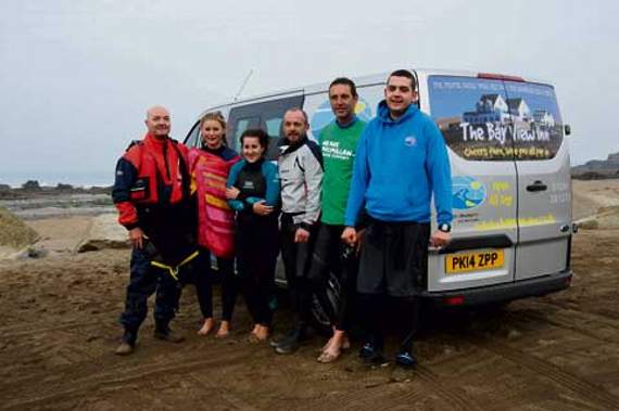 The swimmers and kayakers gather after completing the fundraising challenge.
