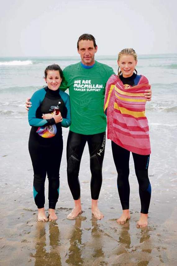 Yazmin Allsworth, Gary Readman and Molly Mees are happy to arrive at Widemouth after the six-mile swim.