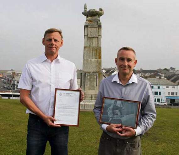 Dominic Owen (left) and David Cross at Bude War Memorial with a framed certificate of thanks from the New Zealand Defence Force and the photograph of Plt Officer Boreham. Picture: Paul Hamlyn