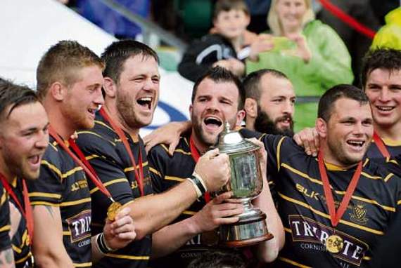 BEN Hilton and Cornwall skipper Kyle Marriott hold aloft the Bill Beaumont Cup in front of a jubilant crowd in May last year. Picture: Graeme Truby/Pinnacle