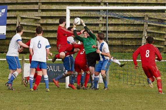 CAMELFORD’S goalkeeper Paul Hider takes the ball off the head of Exmouth’s Matt Dawson in a crowded penalty area. Picture: David Flower