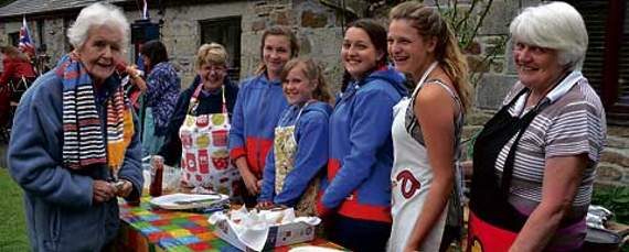 Hot dogs supplied by St Breward Guides — Christine Woolf orders her food, from Brownie leader Marilyn Pluess, guides Elle-Mae Best, Imogen Morris, Bethany Bailey-Brown and Zara Teague, with helper Pam Davy. Picture: Peter Glaser
