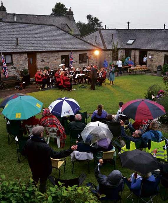 The rain sodden band, defiant to the end of a slightly shortened concert due to the inclement weather in the second half of the concert. Picture: Peter Glaser