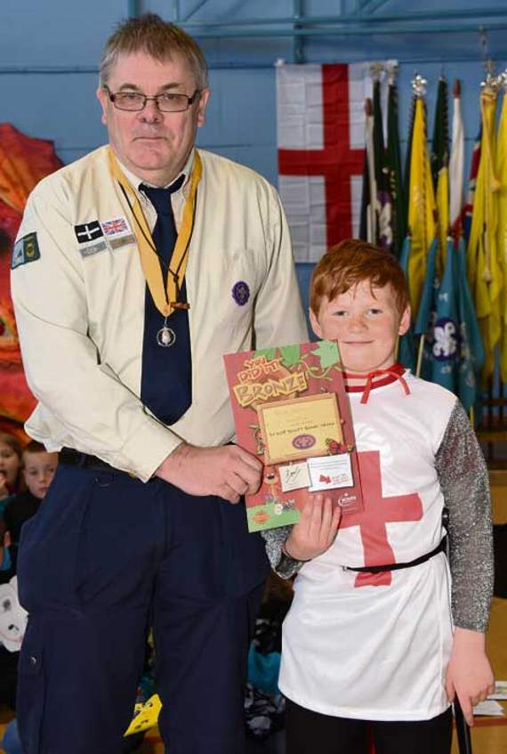 George Butcher of the 1st Camelford Scouts receives his Chief Scouts Bronze Award from the district commissioner, David Illsley. Picture: Adrian Jasper